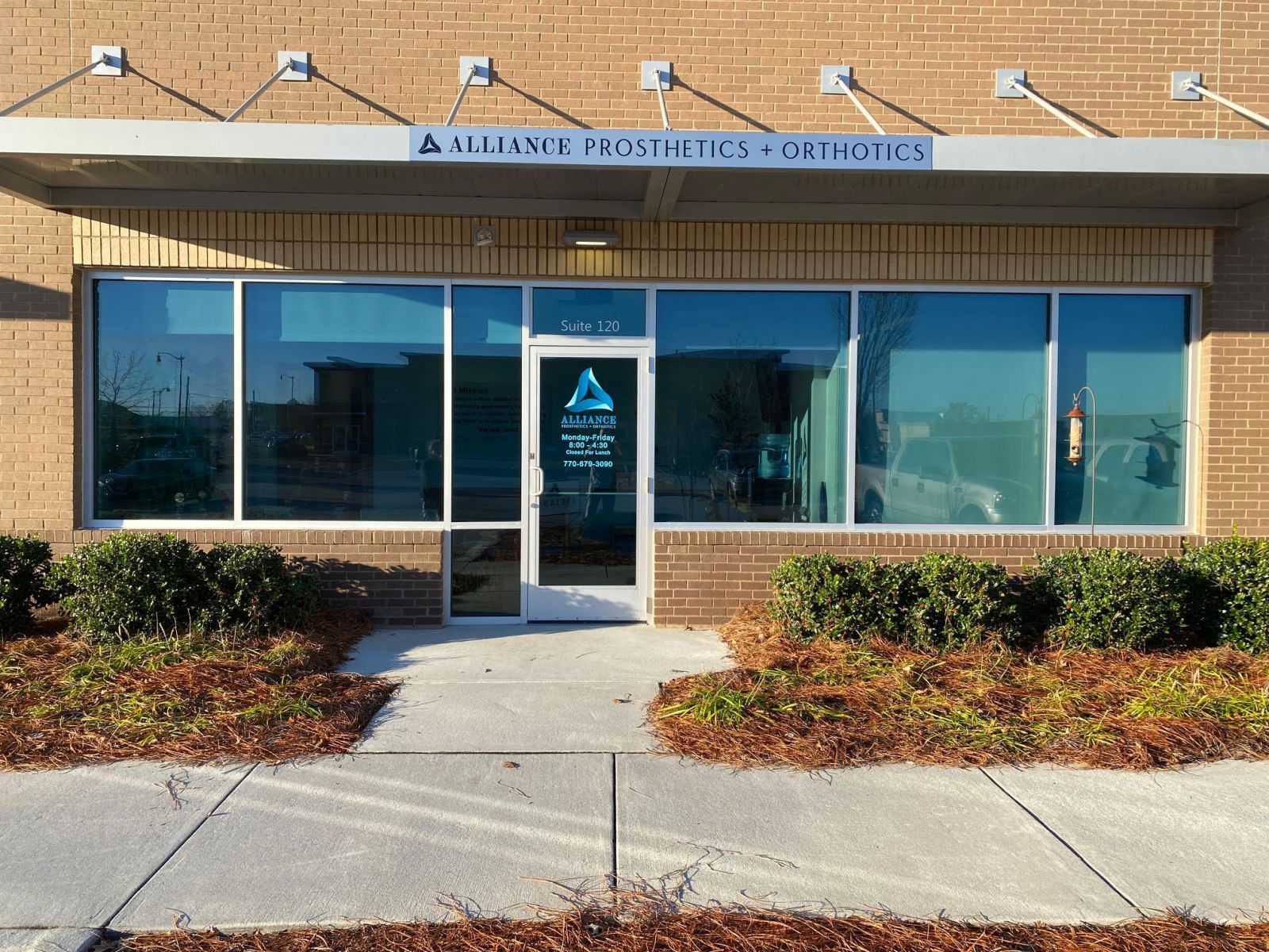 Exterior view of Advanced Prosthetics & Orthotics clinic with large windows and a covered entrance.