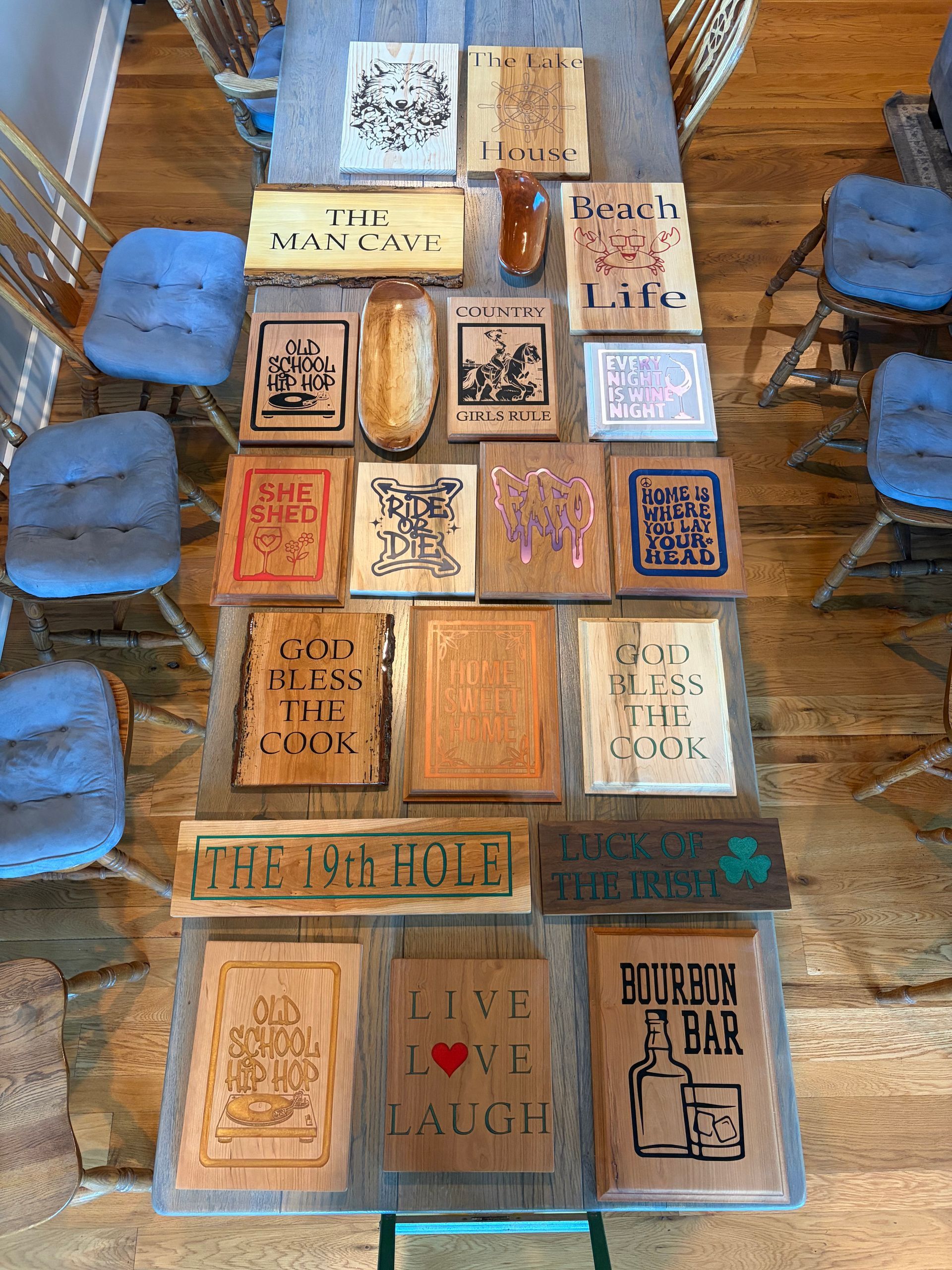 Top-down view of wooden crate-style table tops in a café, with colorful printed designs and chairs around it