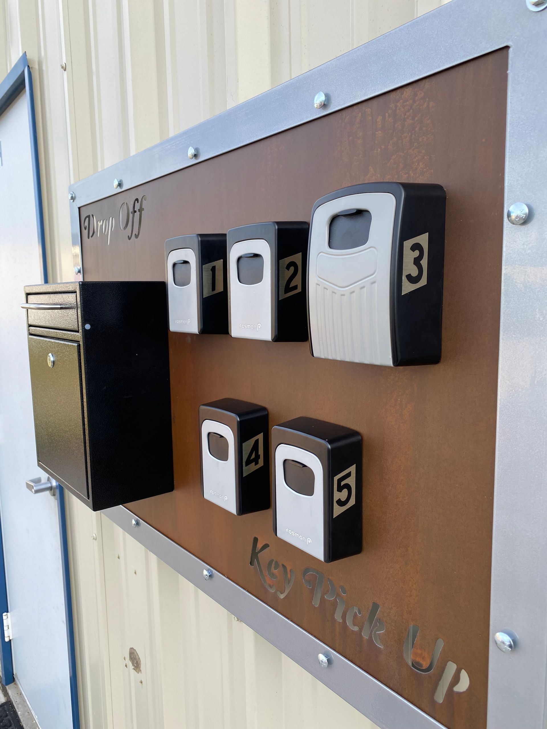Brown wall panel with six numbered push-button boxes, likely a game or control board