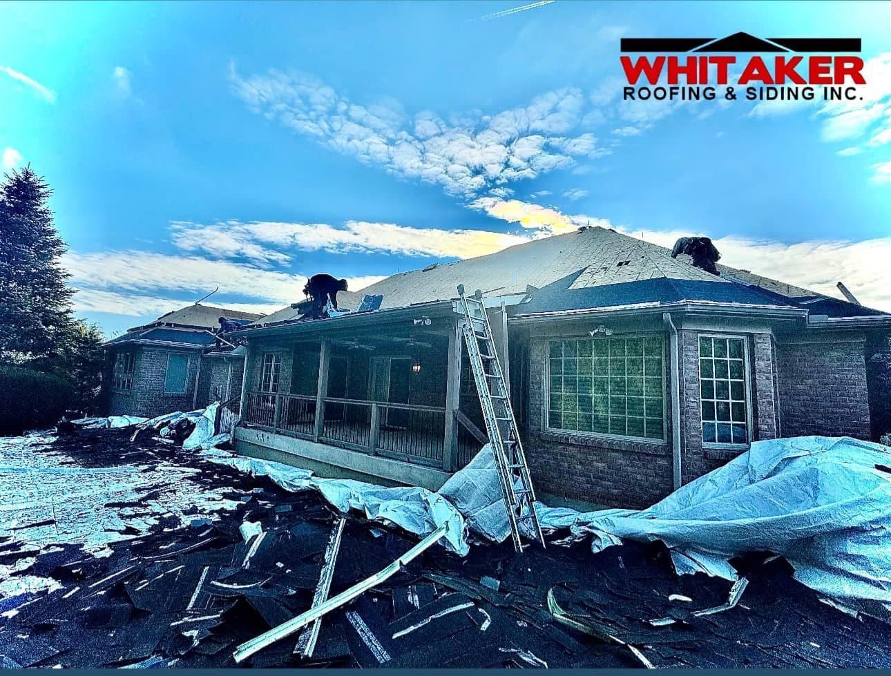 A picture of a house being demolished by whittaker roofing and siding
