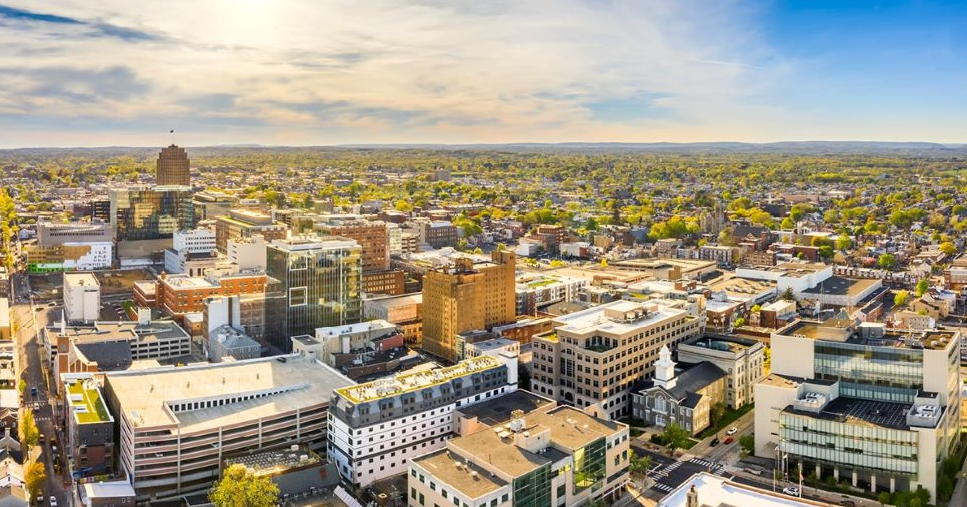 An aerial view of a city with lots of buildings and trees.