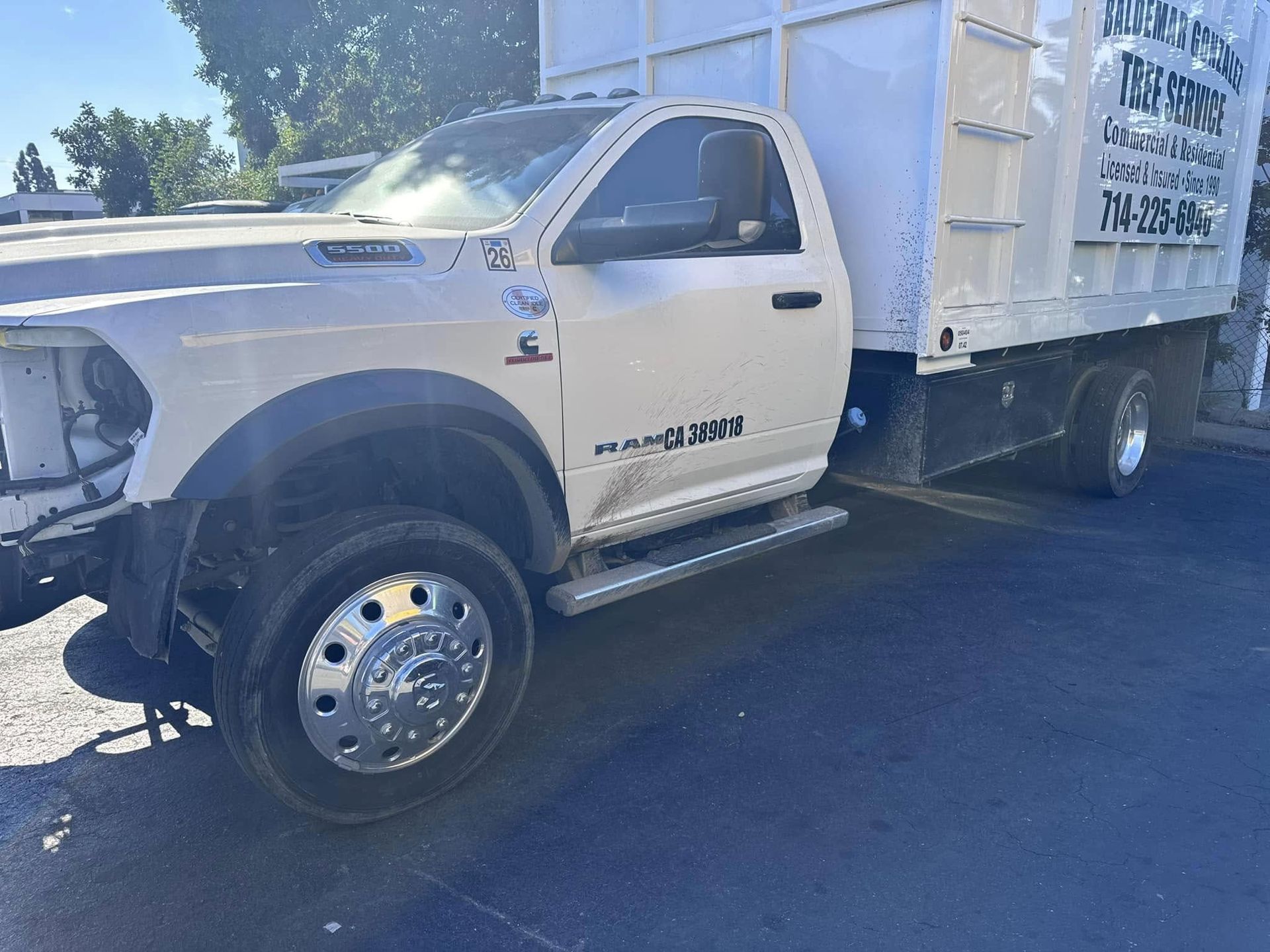 White Ram 4500 work truck with a dump bed. It's parked on asphalt in an outdoor setting.