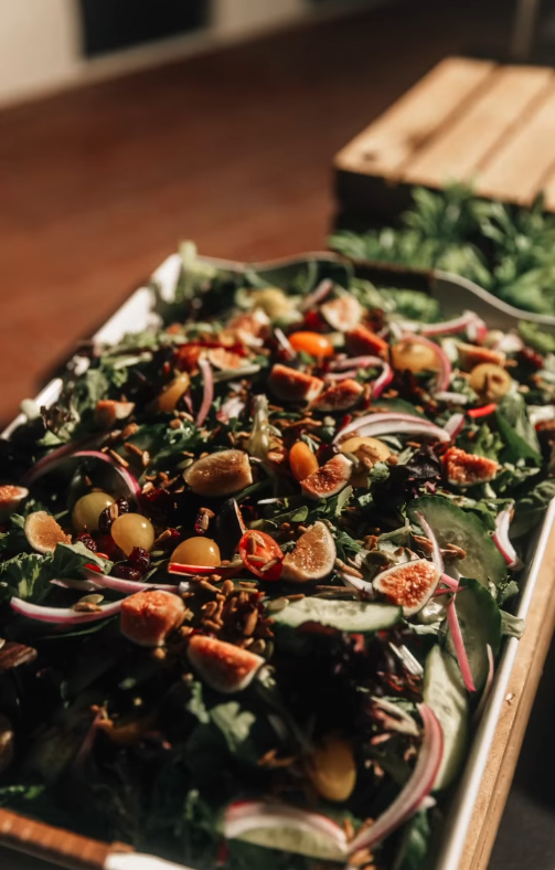 A close up of a salad on a tray on a table.