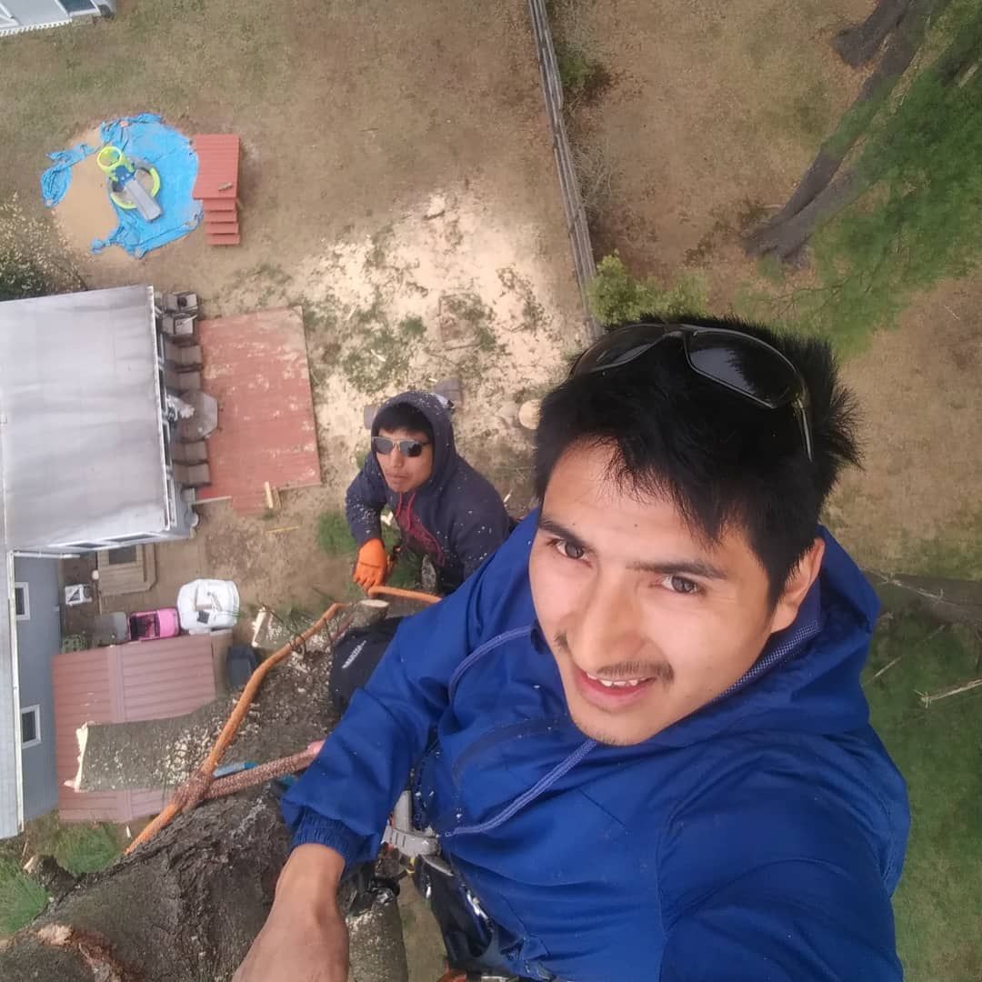 A man in a blue jacket is taking a selfie