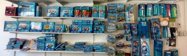 Store shelves stocked with assorted blue packaged snacks and candy bars