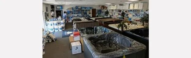 Indoor rock and mineral shop with display cases, shelves, and polished stones throughout the room