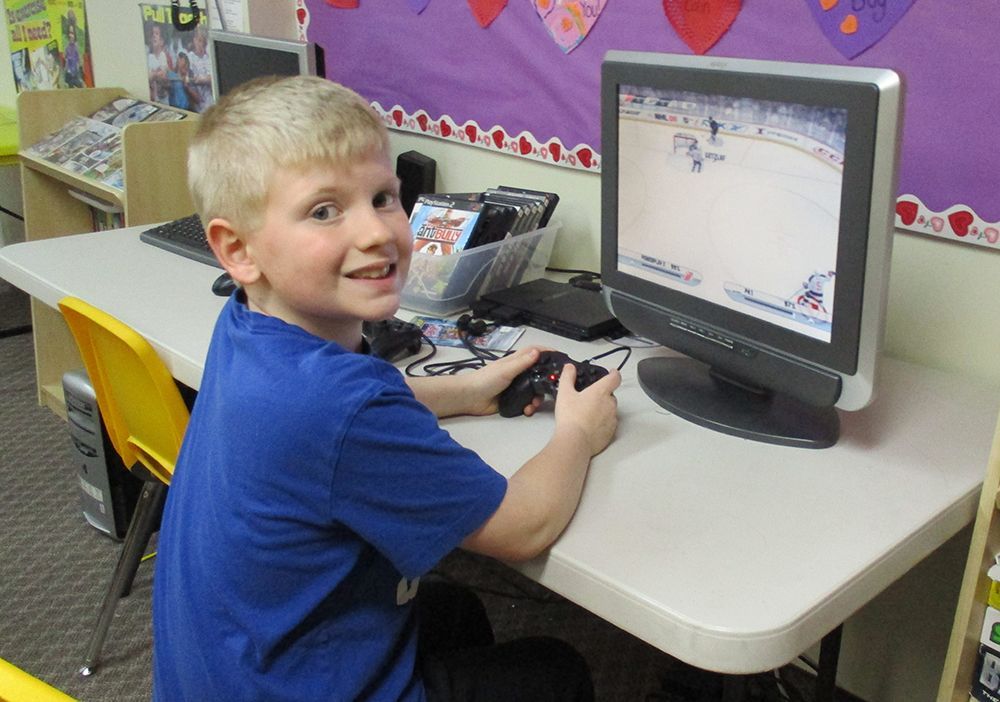 Young boy playing hockey on a console