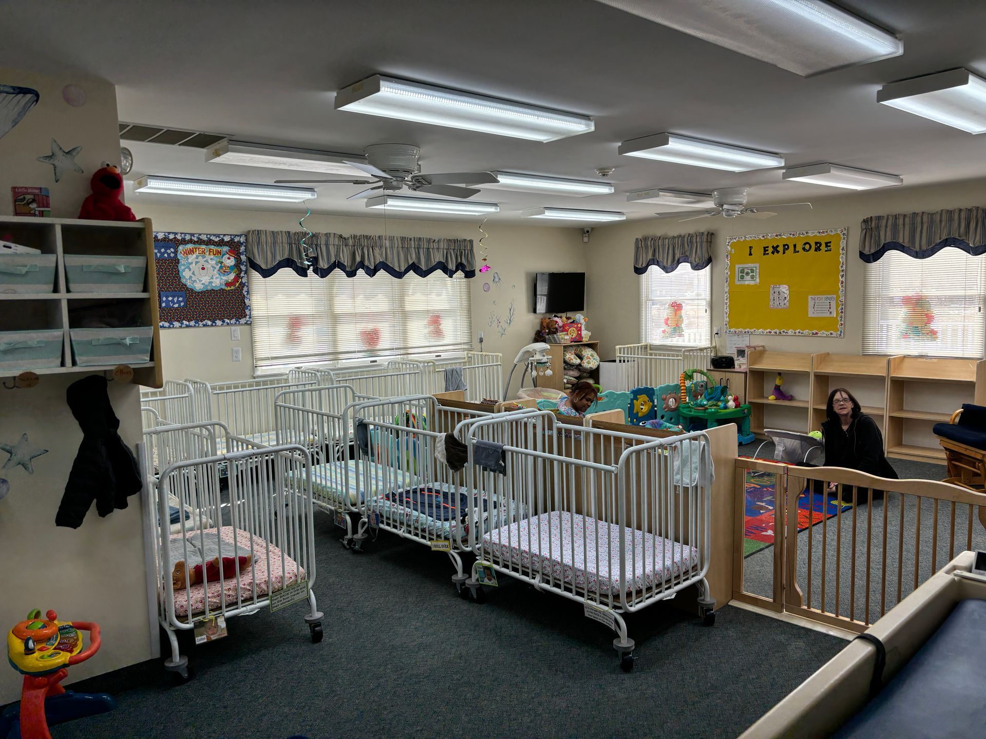 A room filled with lots of cribs and toys.