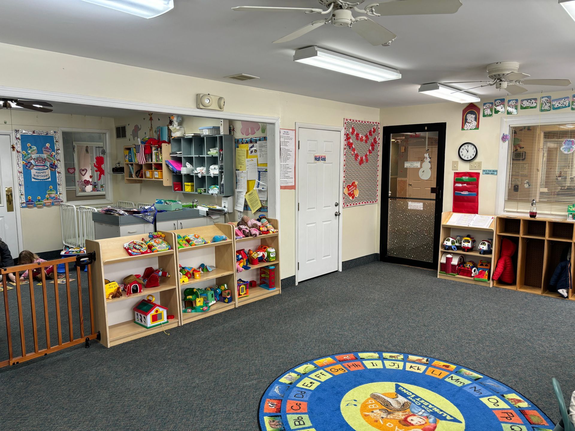 A room filled with lots of toys and a rug.