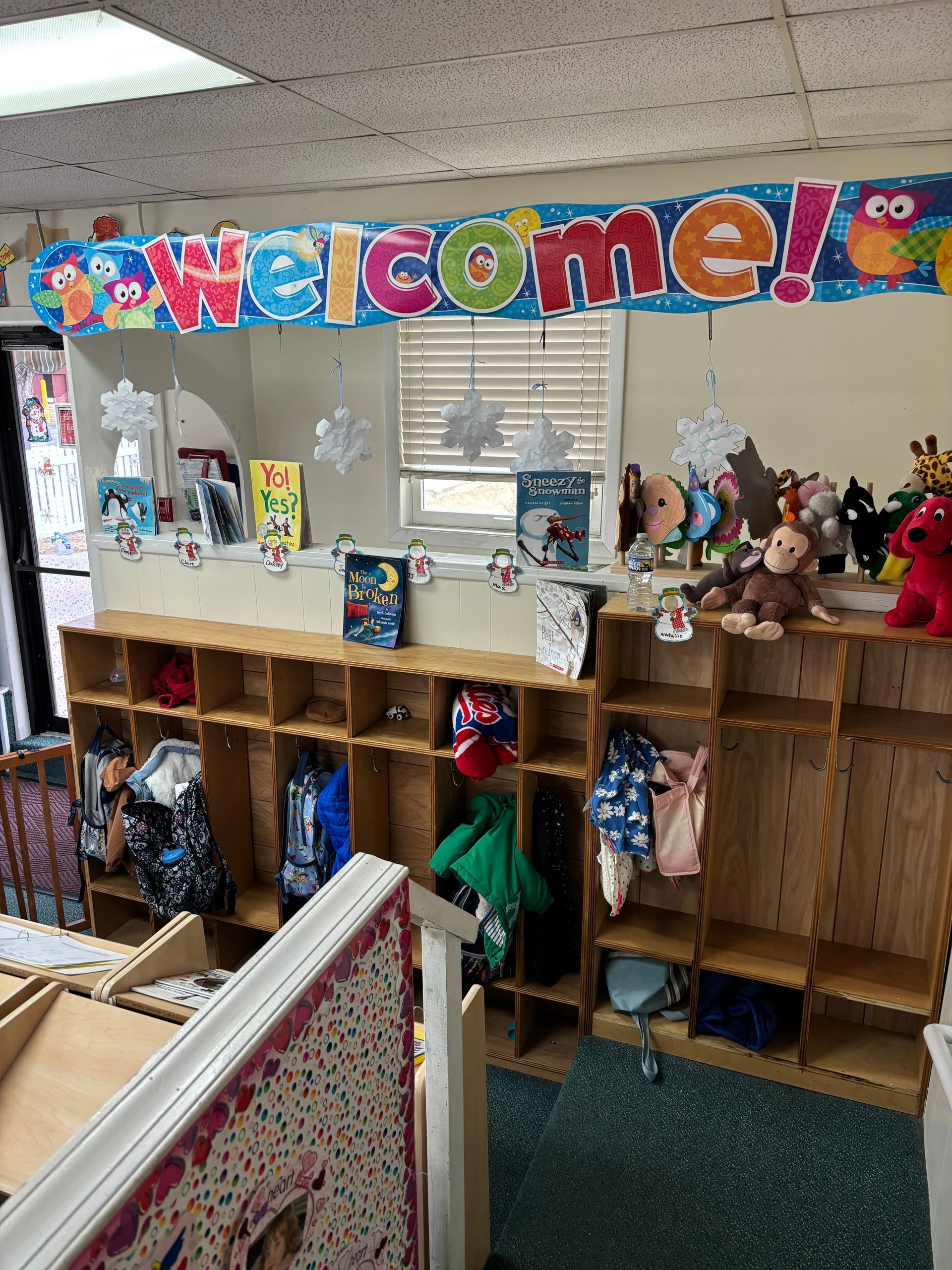 A classroom with a welcome sign hanging from the ceiling