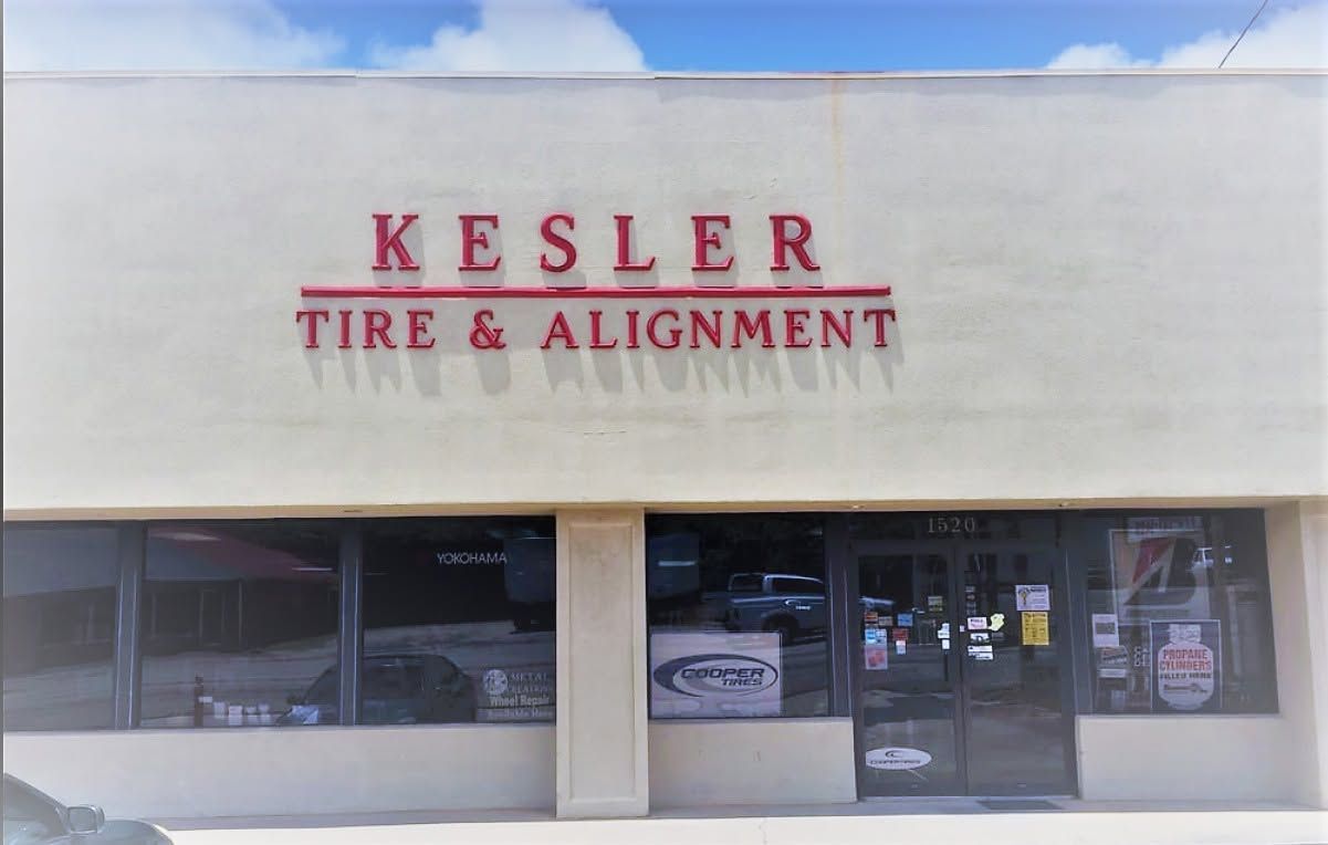 Kesler Tire & Alignment storefront with red signage on a beige building