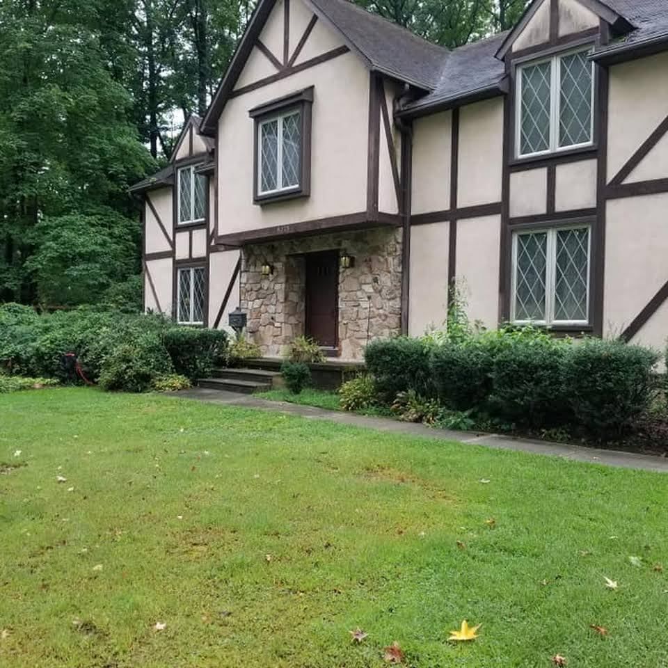 A large house with a large lawn in front of it
