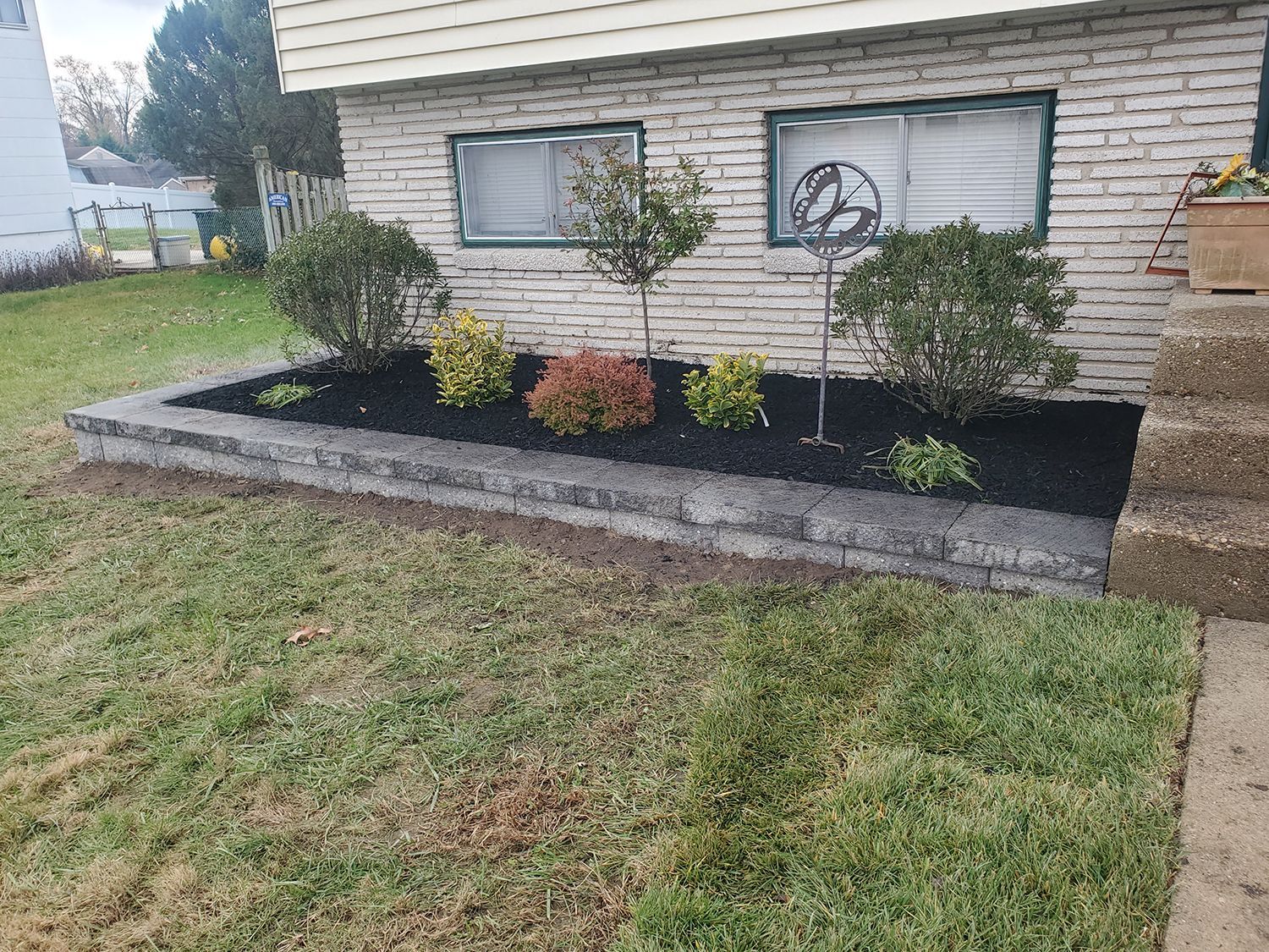 A brick house with a garden in front of it.