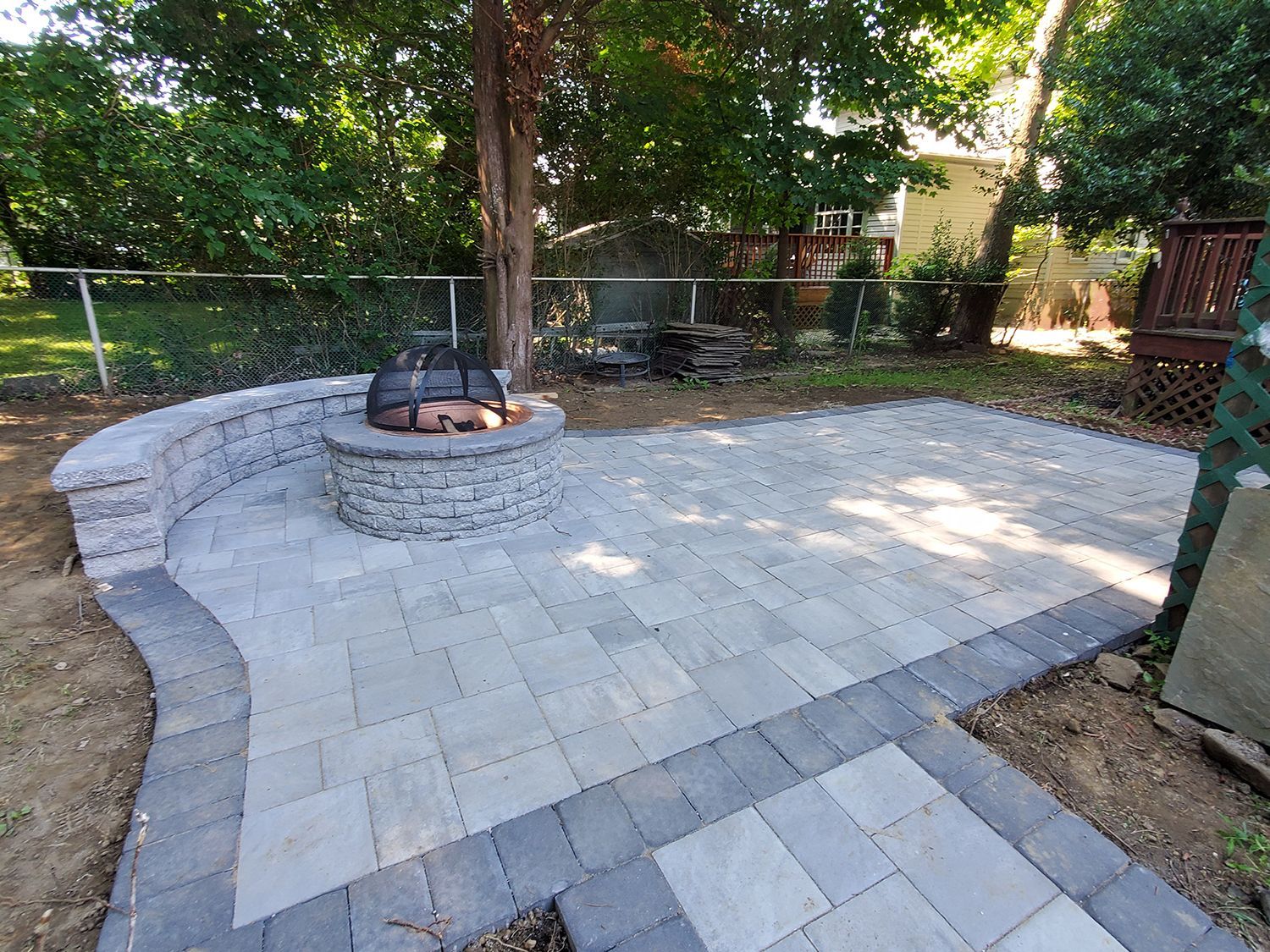 There is a fire pit in the middle of the patio.