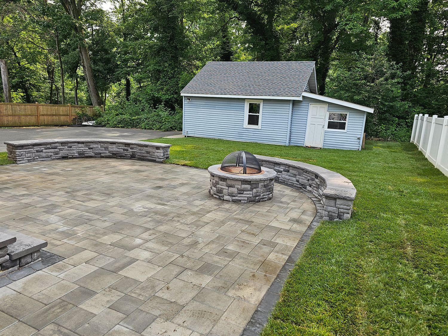 There is a fire pit in the middle of the patio.