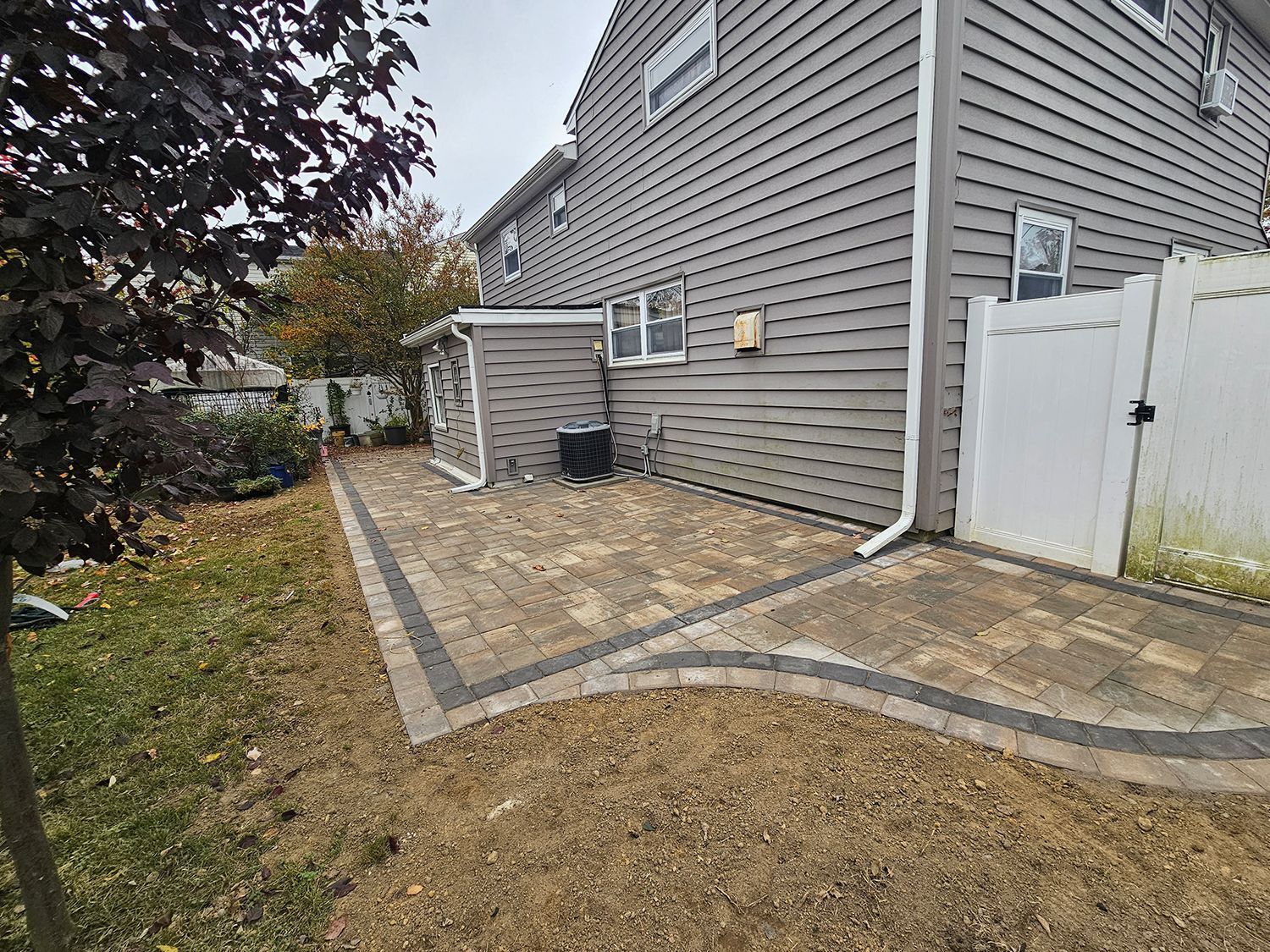 A white house with a brick porch and steps