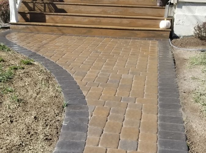 A brick walkway leading to a set of stairs