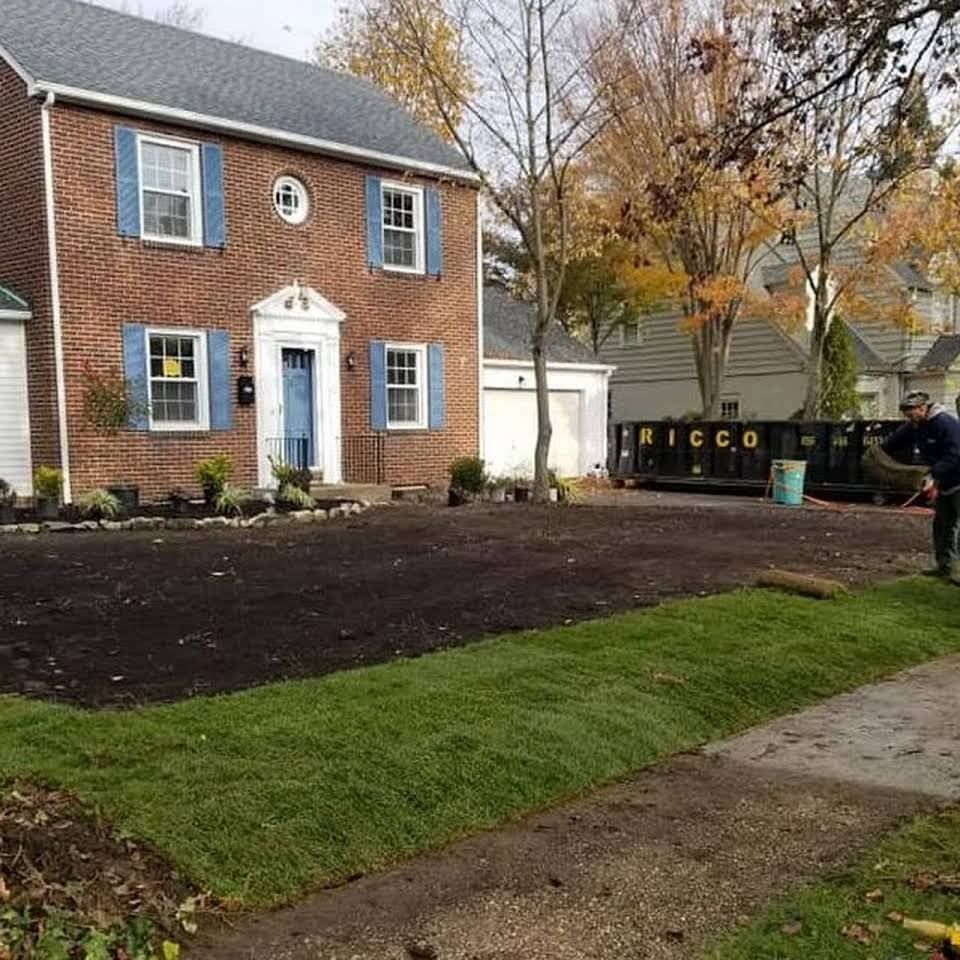 A brick house with blue shutters is being remodeled