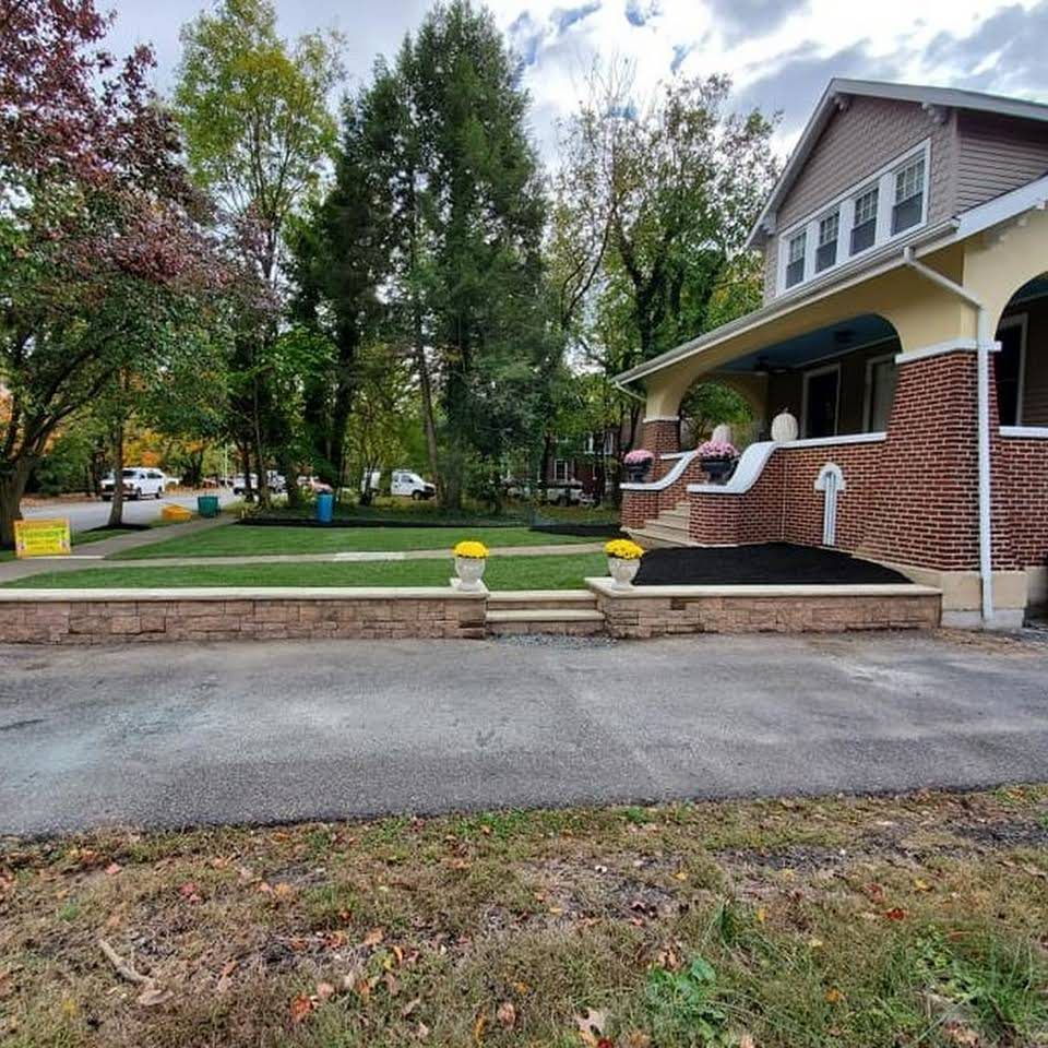 A brick house with a large lawn in front of it