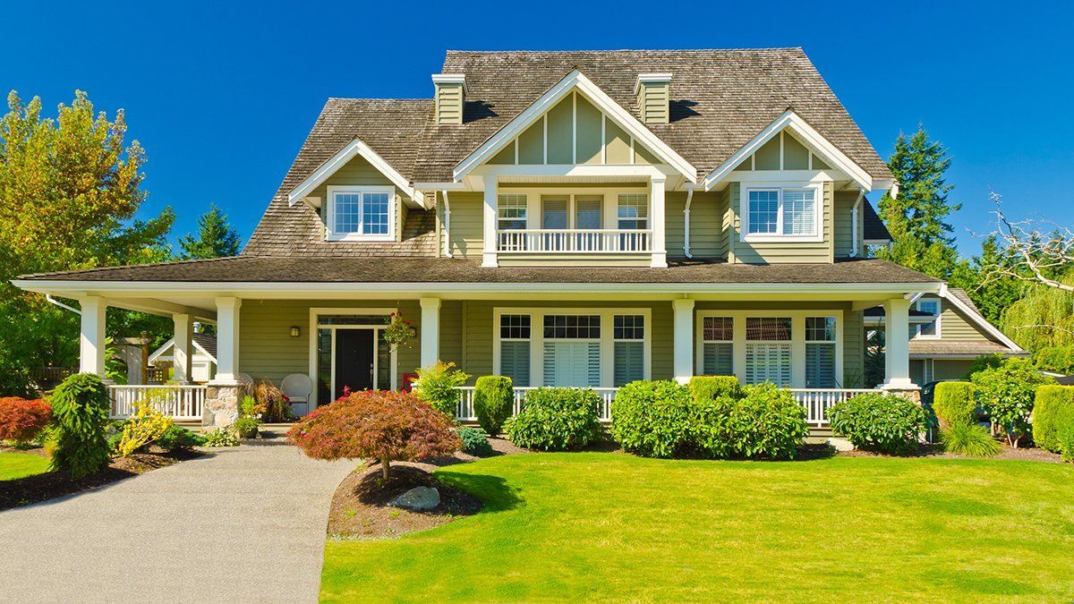 A large house with a large lawn in front of it.
