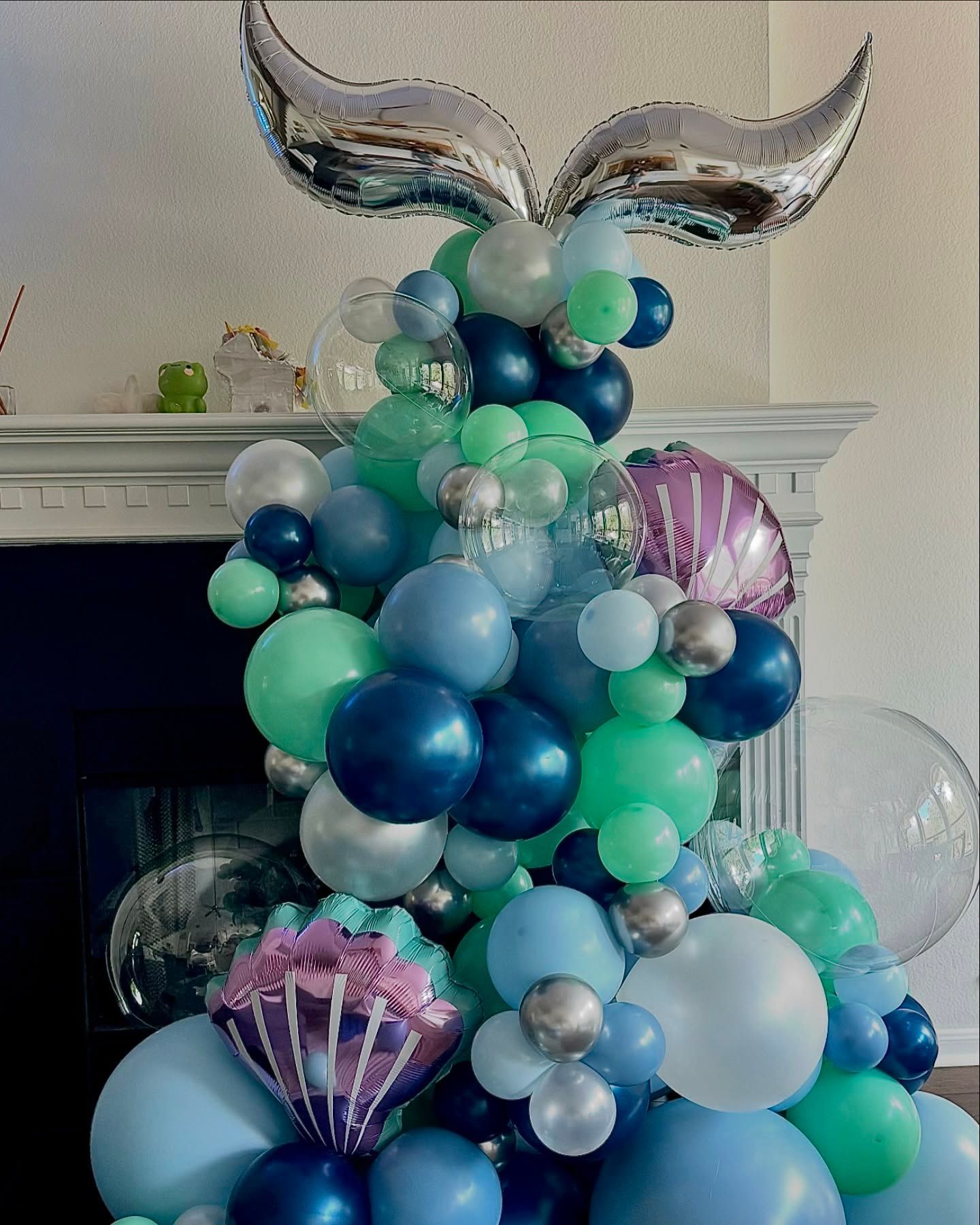 A bunch of balloons are stacked on top of each other in a room.