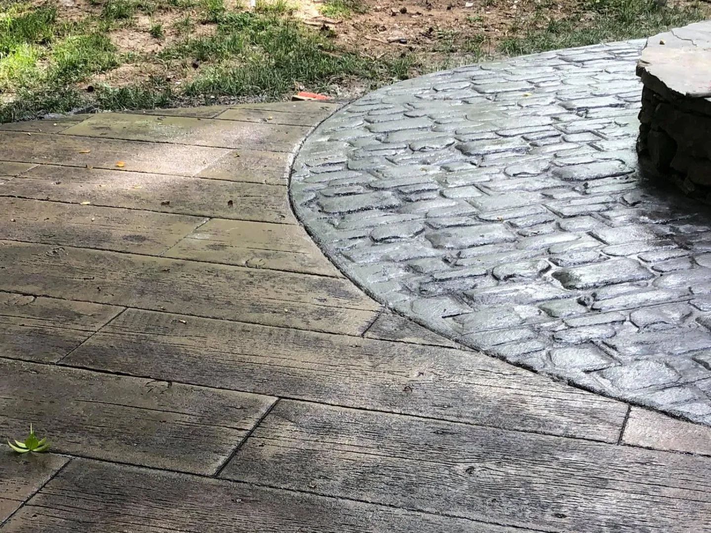 Stamped concrete patio with wood and cobblestone patterns.