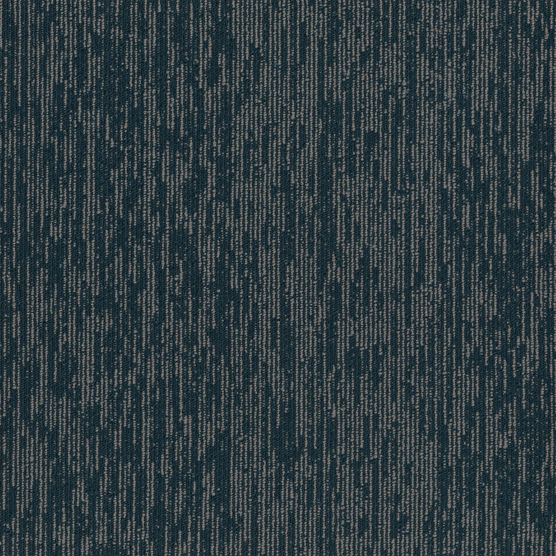 A close up of a blue carpet with a pattern on it.