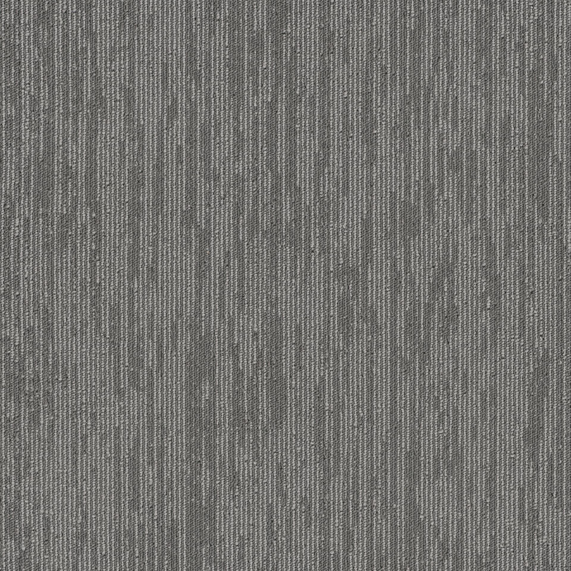 A close up of a gray carpet with a striped pattern.