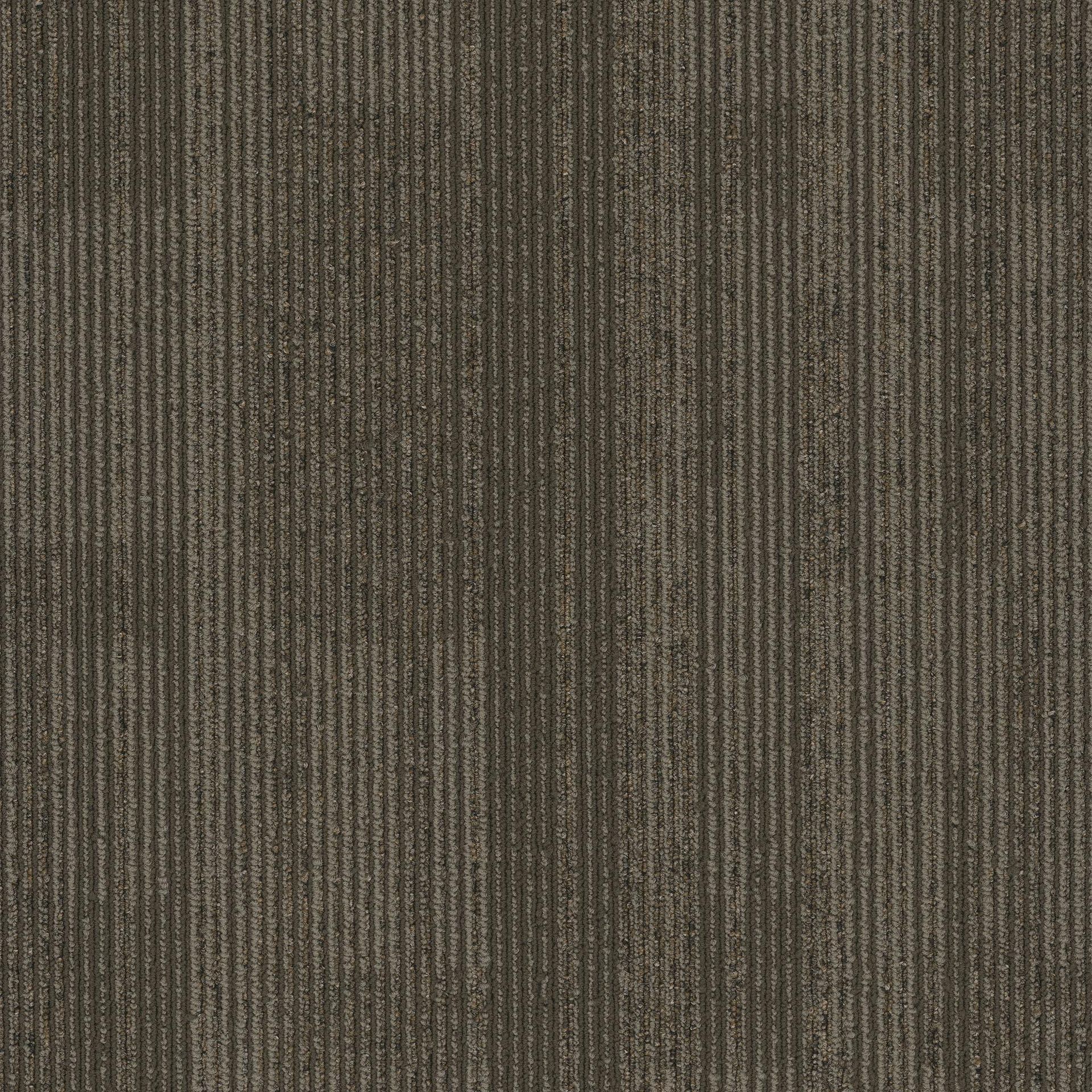 A close up of a brown carpet with a striped pattern.