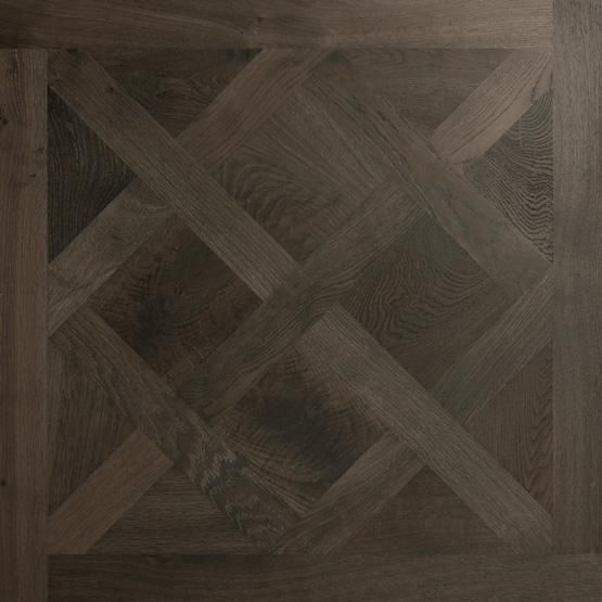 A close up of a wooden floor with a pattern on it.