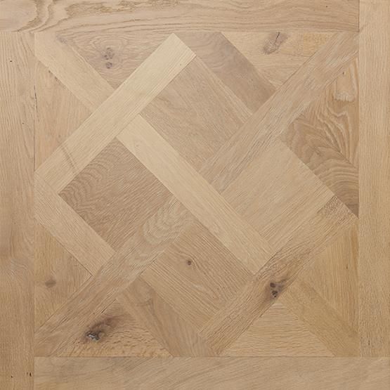 A close up of a wooden floor with a pattern on it.