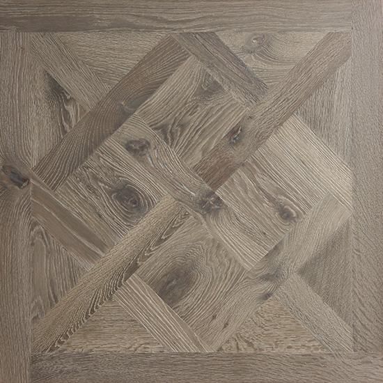 A close up of a wooden floor with a pattern on it.