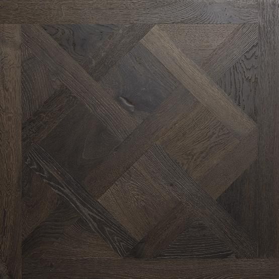 A close up of a wooden floor with a pattern on it.