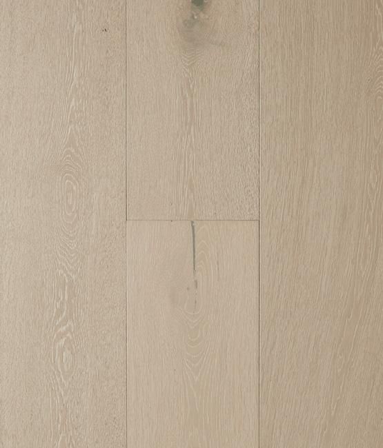 A close up of a white wooden floor with a knot in it.