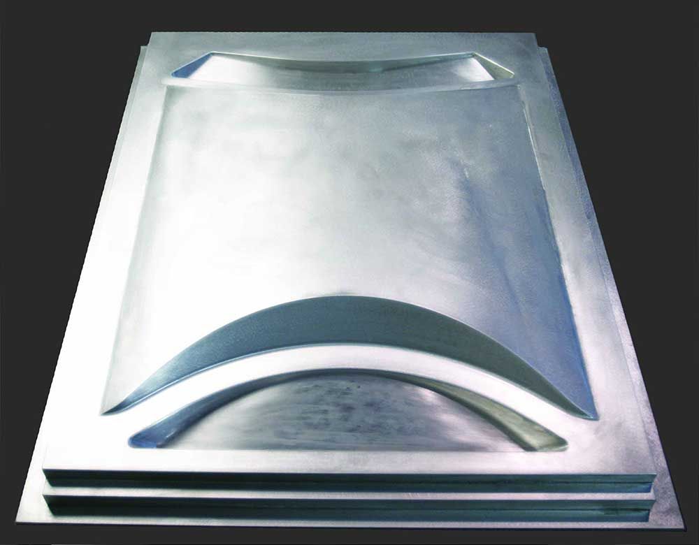 A piece of metal that looks like a tray with a hole in the middle