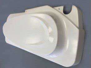 A white plastic object is sitting on a table.