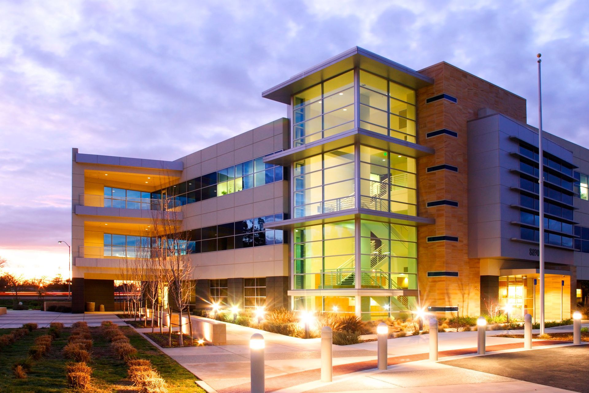 A large building with a lot of windows is lit up at night