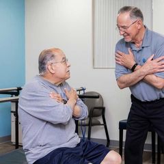 Two men are talking to each other in a room