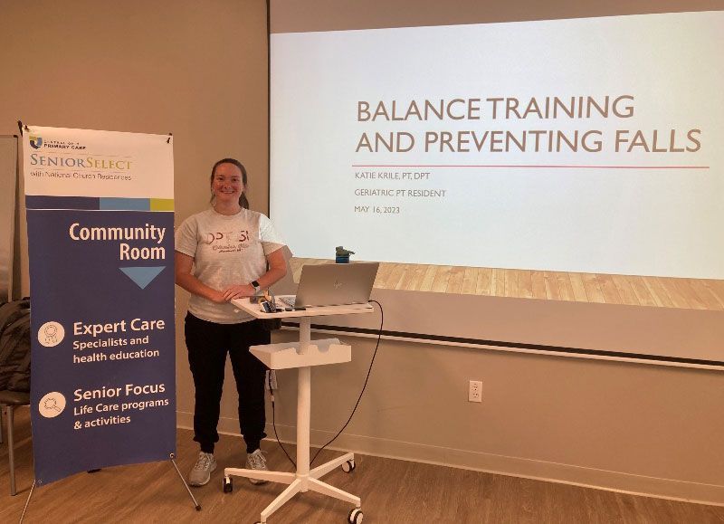 A woman is giving a presentation about balance training and preventing falls.