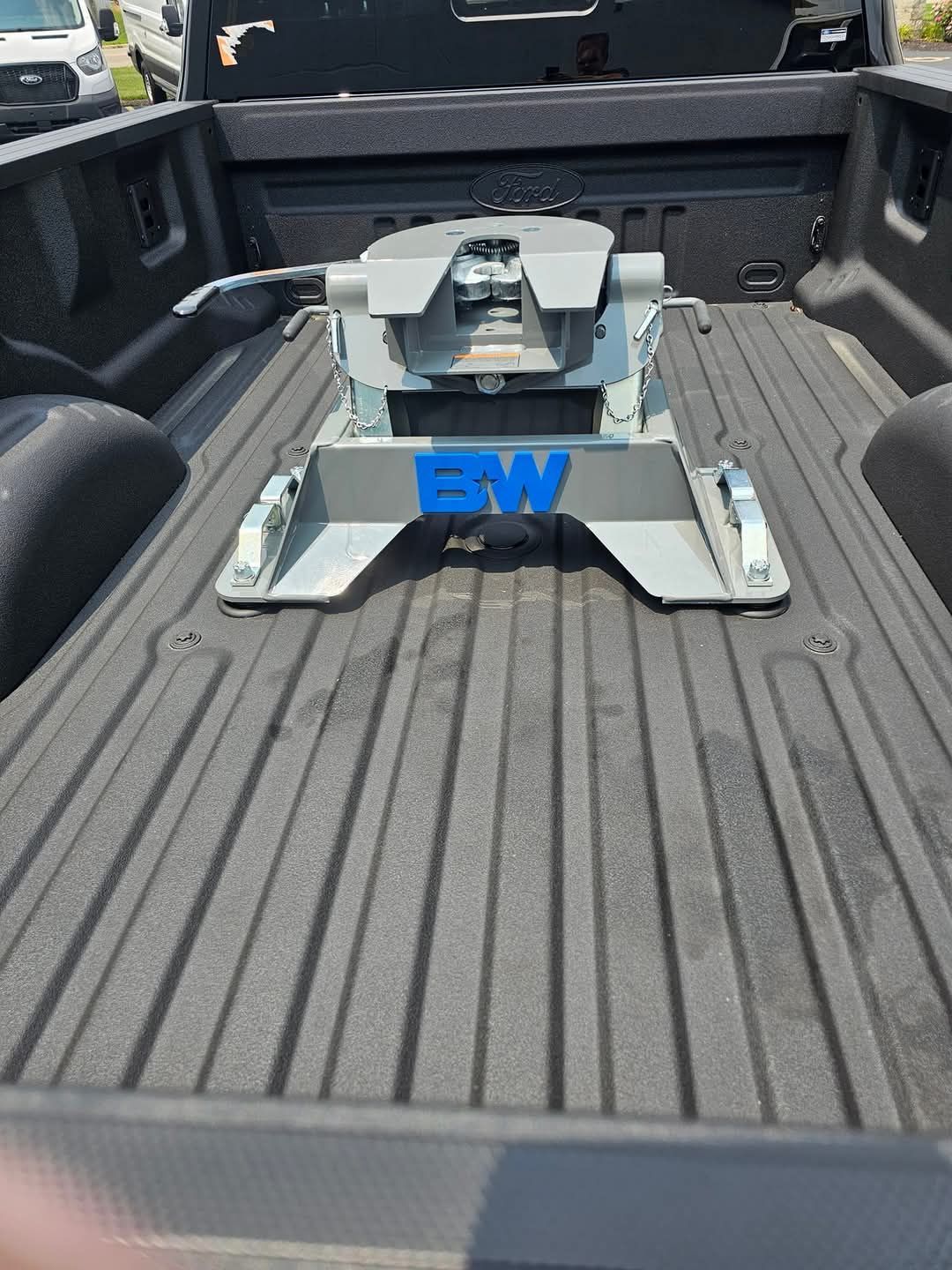 A fifth-wheel hitch (BW brand) installed in the bed of a pickup truck, ready for towing.
