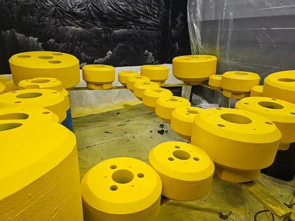 Yellow industrial parts arranged in a workshop.