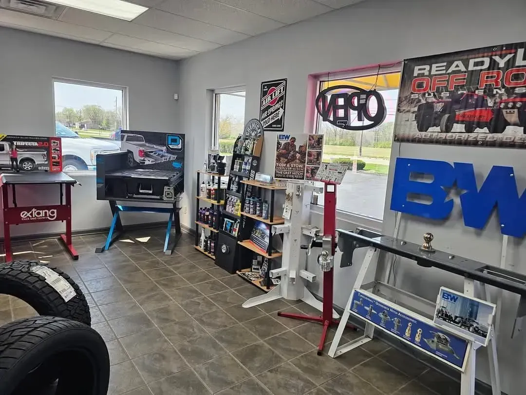 Interior of an RC hobby shop, with shelves of products, tires, and work stations.
