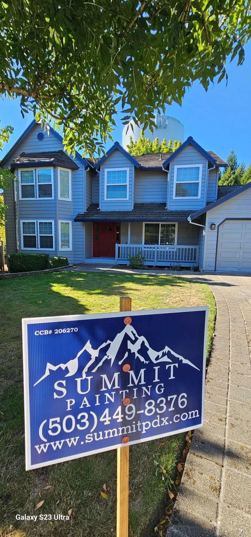 A blue two-story house with a 