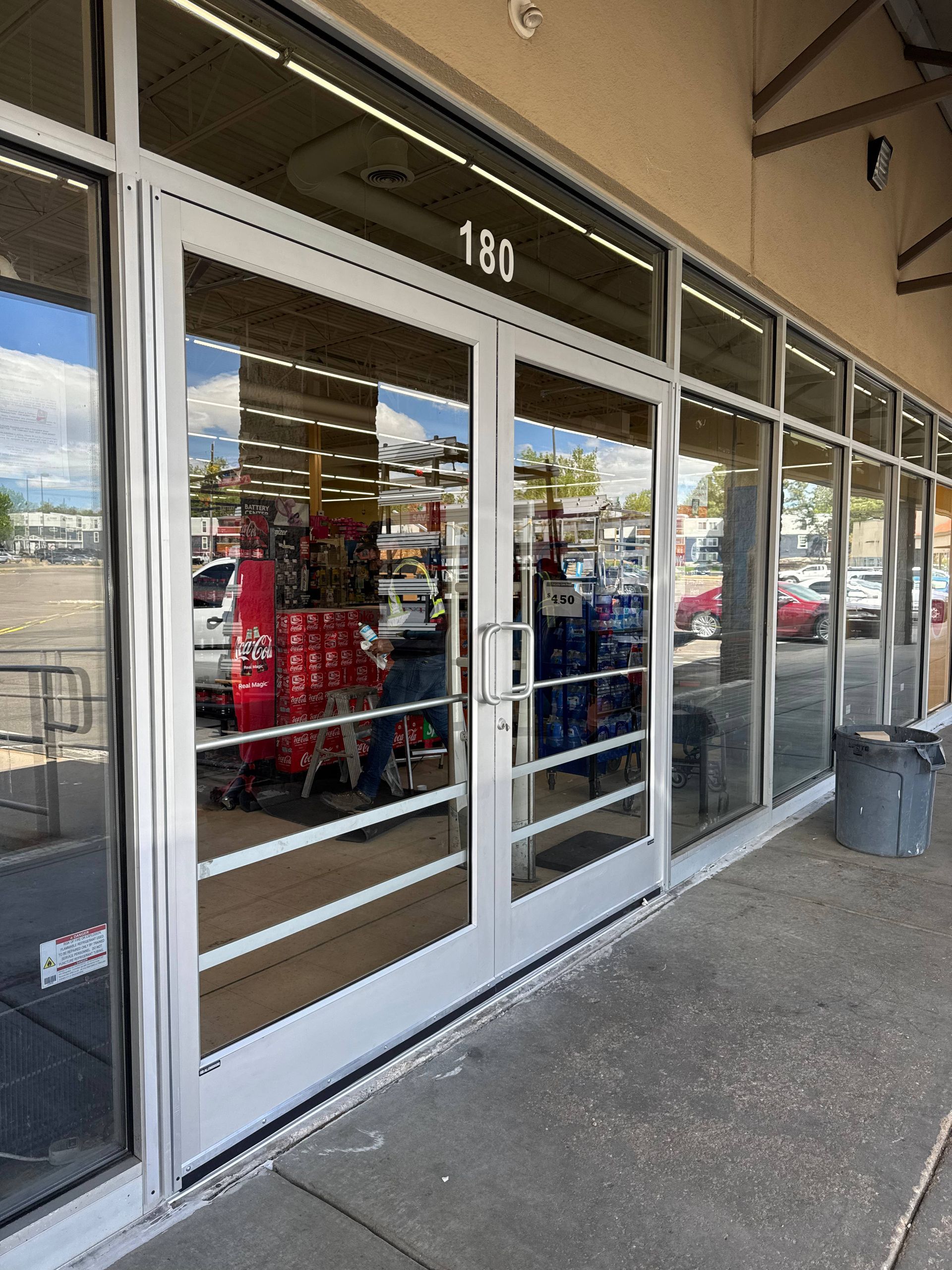 Exterior of a store with glass doors and windows. The number 181 is above the entrance.