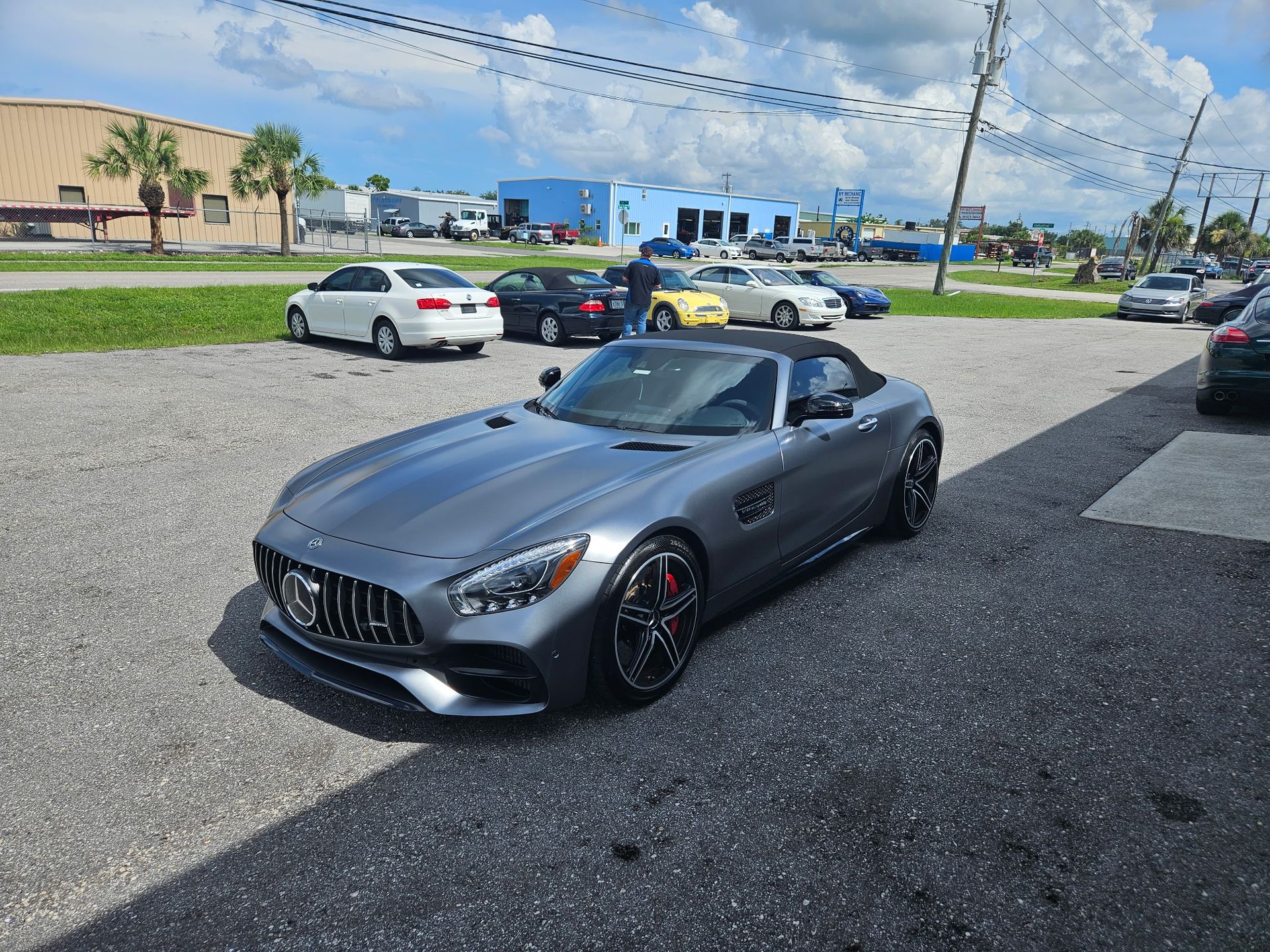 A mercedes amg gt convertible is parked in a parking lot.