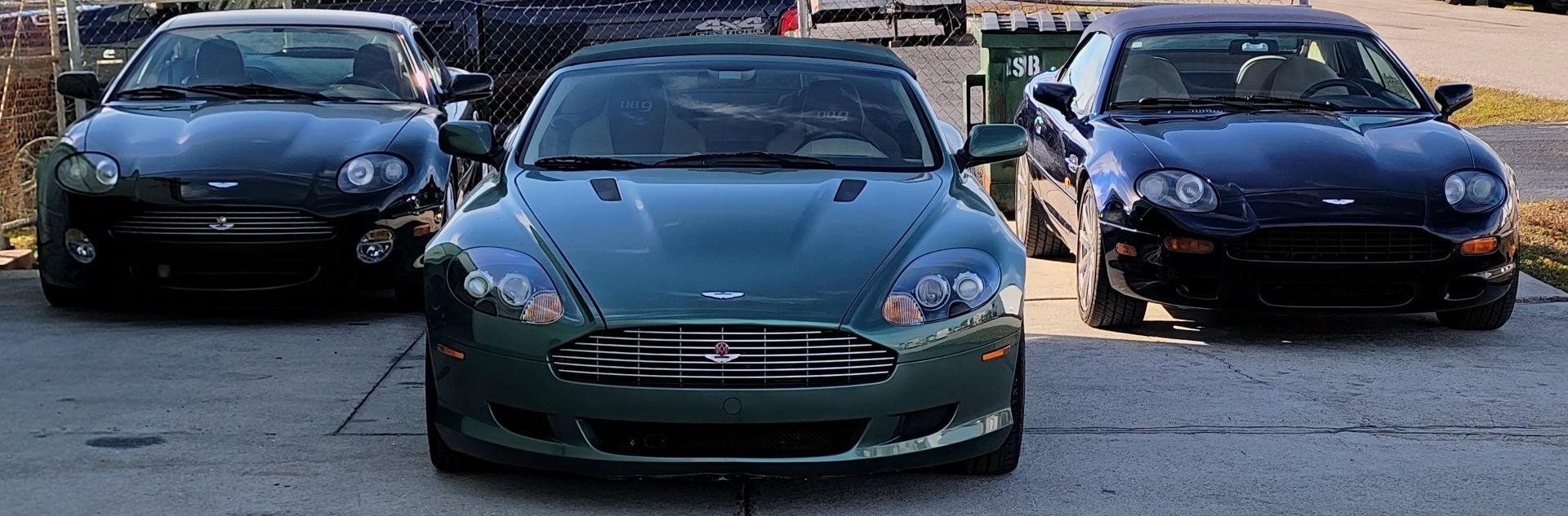 Three cars are parked next to each other on the side of the road.