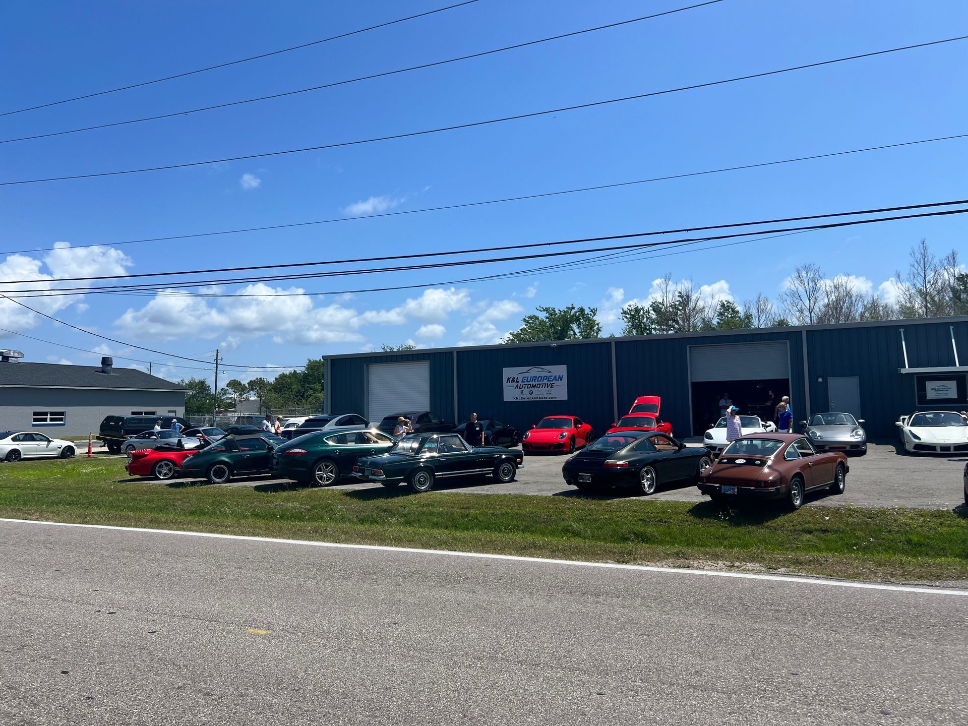 A lot of cars are parked in front of a building