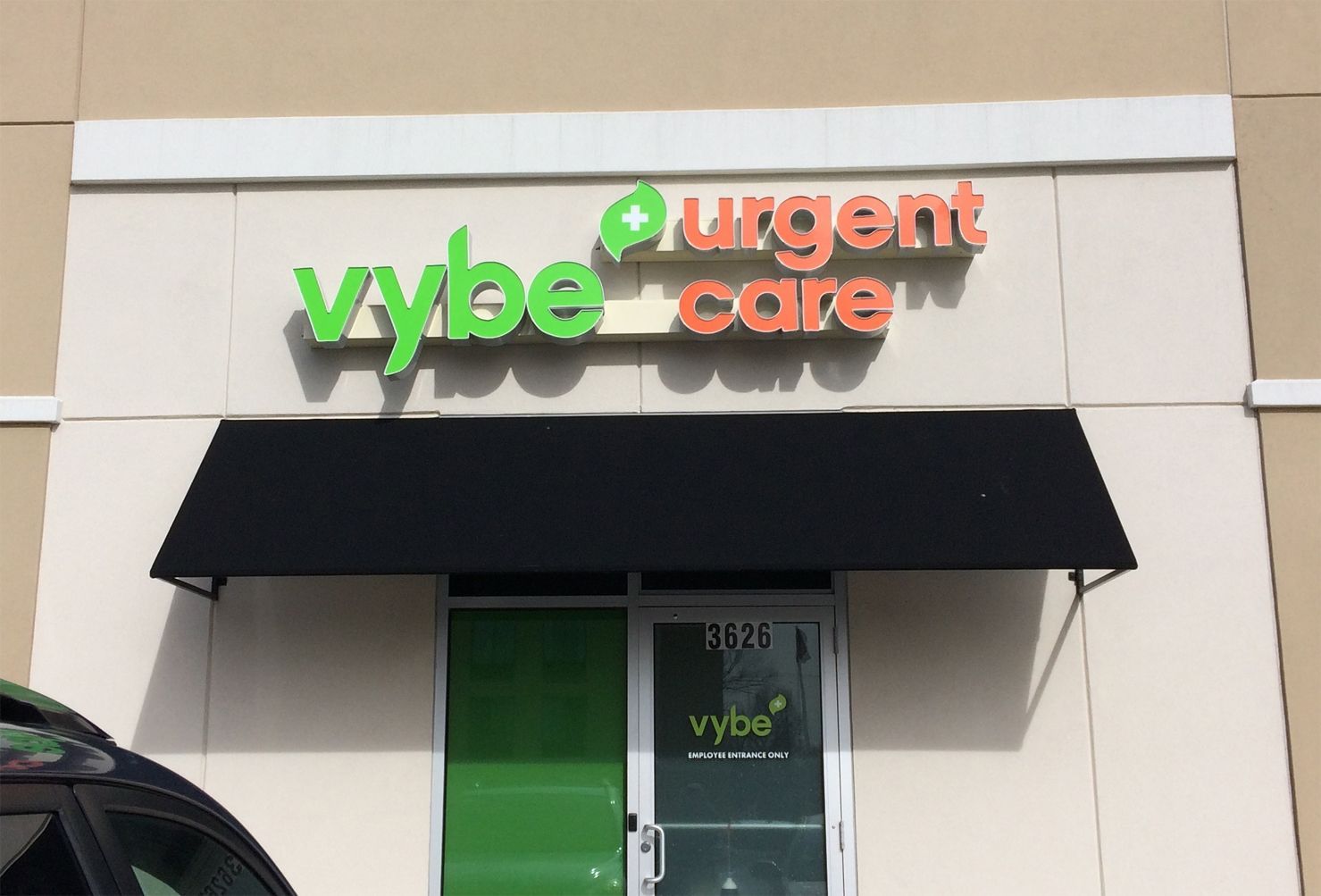 A car is parked in front of a vybe urgent care