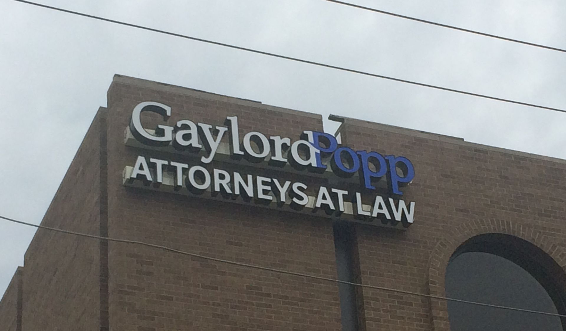 A brick building with a channel letter sign that says Gaylord Popp