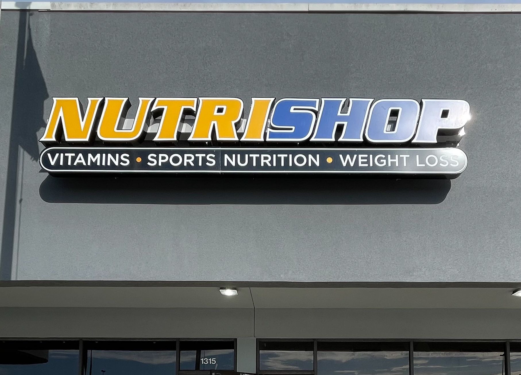 A channel letter sign that says Nutri Shop
